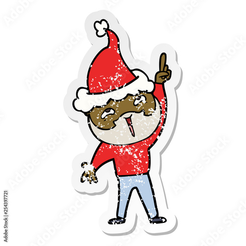 distressed sticker cartoon of a happy bearded man wearing santa hat