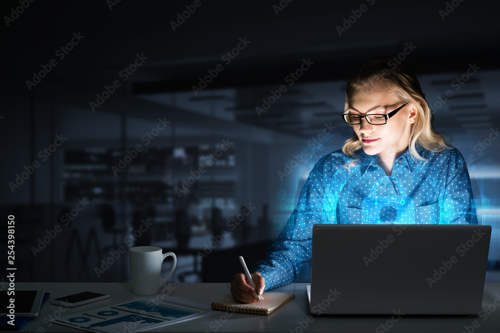Beautiful blonde in dark office working on laptop and getting net access Beautiful blonde in dark office working on laptop and getting net access
