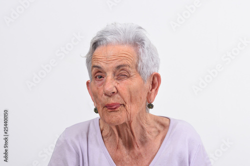 Cuadro en lienzo senior woman wink the eye on white background