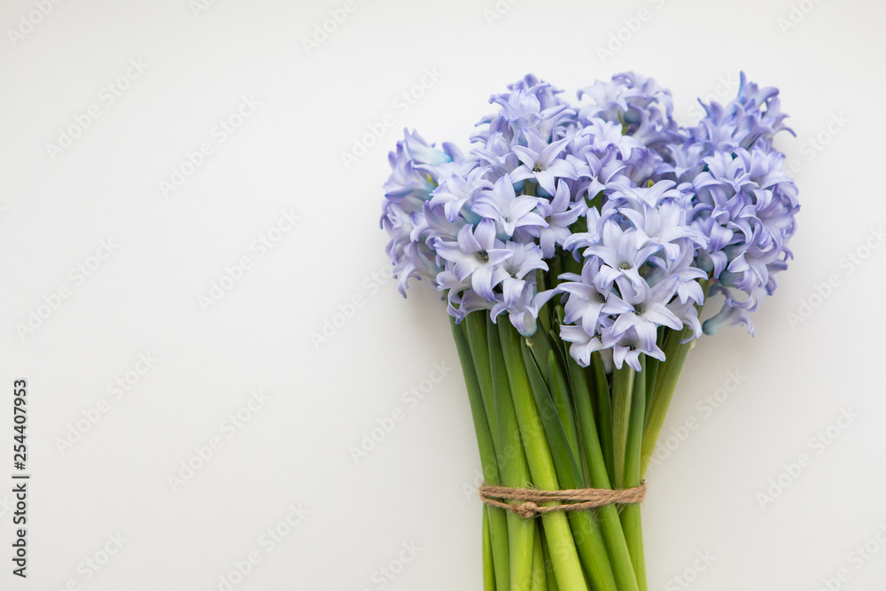 Little Bouquet Of Blue Spring Flowers Hyacinths Wrapped In White Paper On A White Background