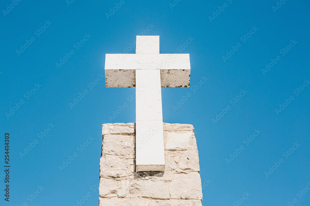 A beautiful view of the Christian Cross at Cape Roca in Sintra in Portugal against the background of a blue sky. A beautiful view of the Christian Cross at Cape Roca in Sintra in Portugal against the background of a blue sky.