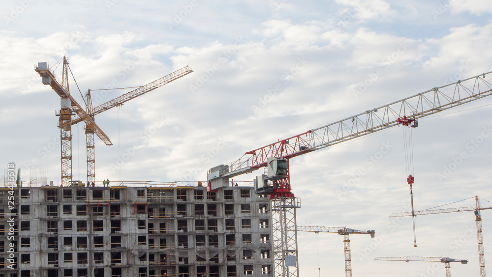 Tower cranes on the construction of new residential buildings Tower cranes on the construction of new residential buildings