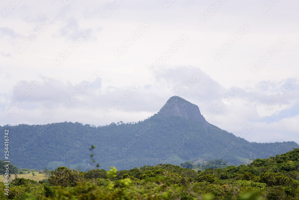 Fototapeta premium Brazilian landscape, road trip in the Espirito Santo state. Wide valleys, nice greenery of atlantic forest and mountains in the background