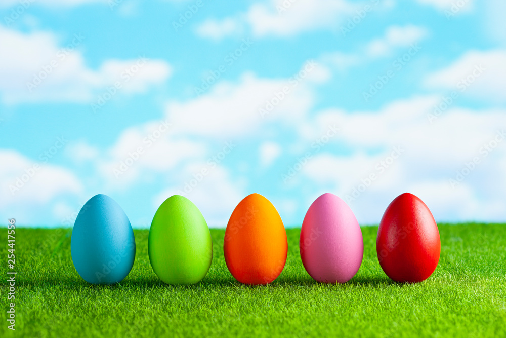 Easter eggs on the grass and blue sky background
