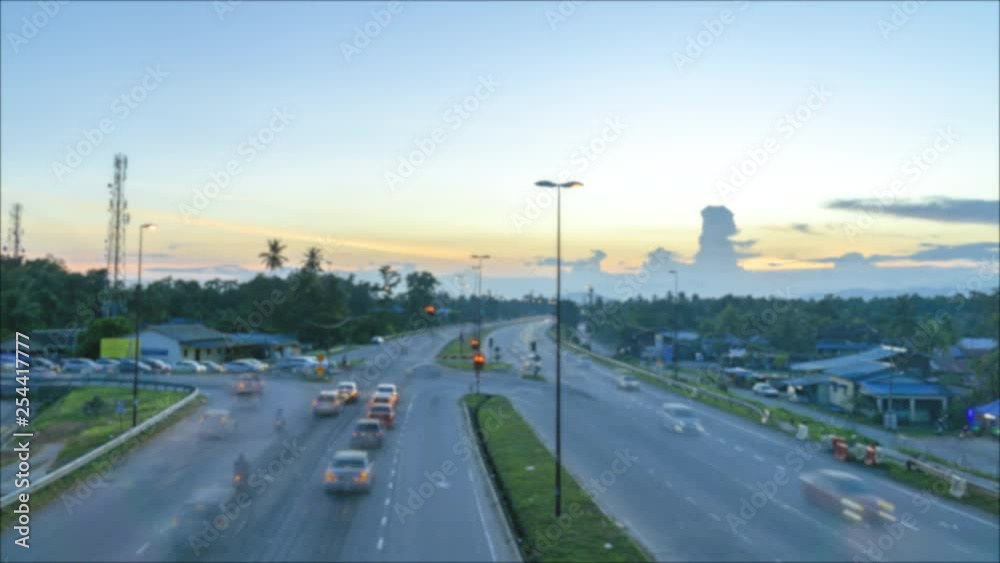 Aerial view time lapse at the traffic lights junction with ultra smooth motion blur vehicle movement on the road during sunset. Aerial view time lapse at the traffic lights junction with ultra smooth motion blur vehicle movement on the road during sunset.