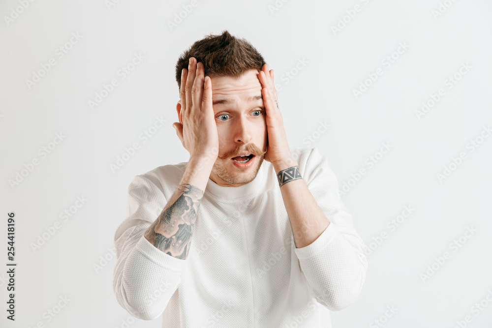 Why is that. Beautiful male half-length portrait isolated on gray studio backgroud. Young emotional surprised, frustrated and bewildered man. Human emotions, facial expression concept. Why is that. Beautiful male half-length portrait isolated on gray studio backgroud. Young emotional surprised, frustrated and bewildered man. Human emotions, facial expression concept.