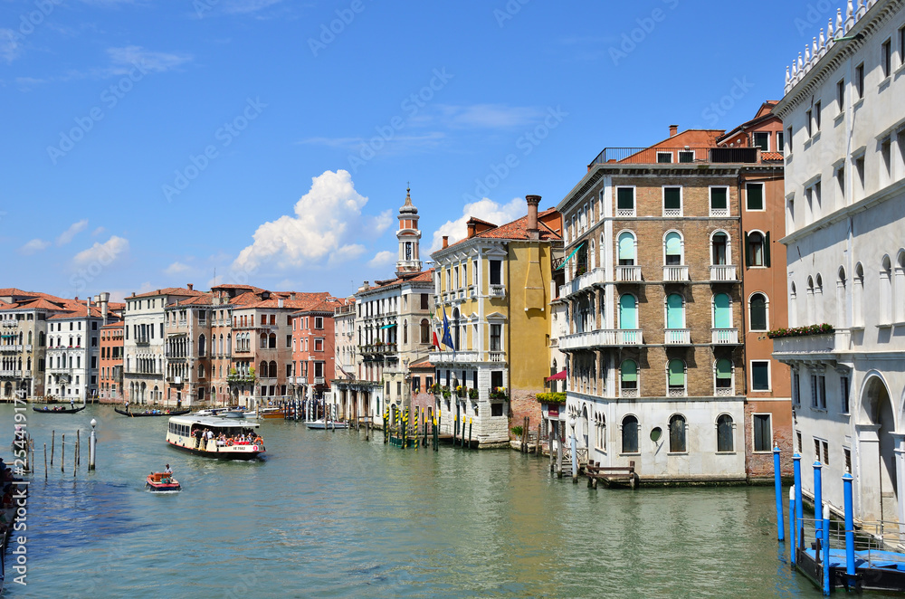 Venetian gondoliers punting gondolas through 