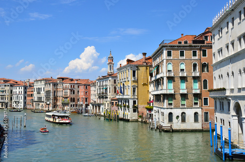 Venetian gondoliers punting gondolas through "canal grande" in Venice.