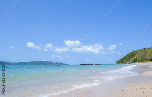 Beautiful beach with soft wave of tropical sea and blue sky. Summer day and sandy beach background. Vacation holidays background wallpaper.