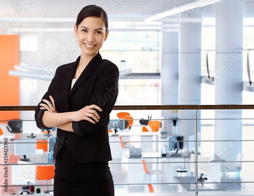 Asian businesswoman at office with arms crossed