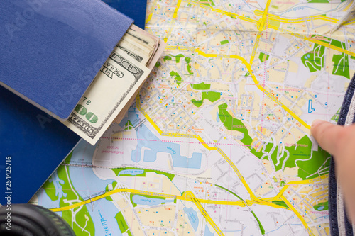 Point of destination on map in traveling. Passport  cash and plans for going. Travel accessories for navigation