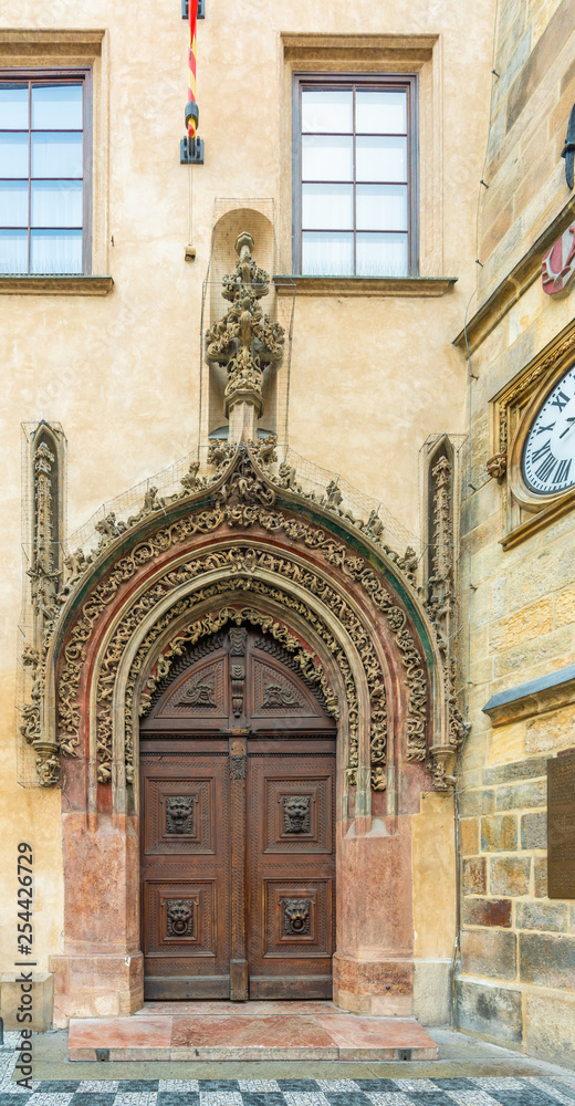 Prague, Czech Republic. Late Gothic door in the house adjacent to the tower serves as the main entrance to the Old Town Hall at the square and it is one of the city's most visited monuments.