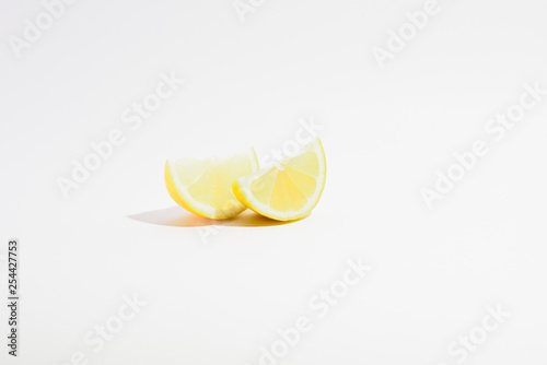 two lemon slices on a white background