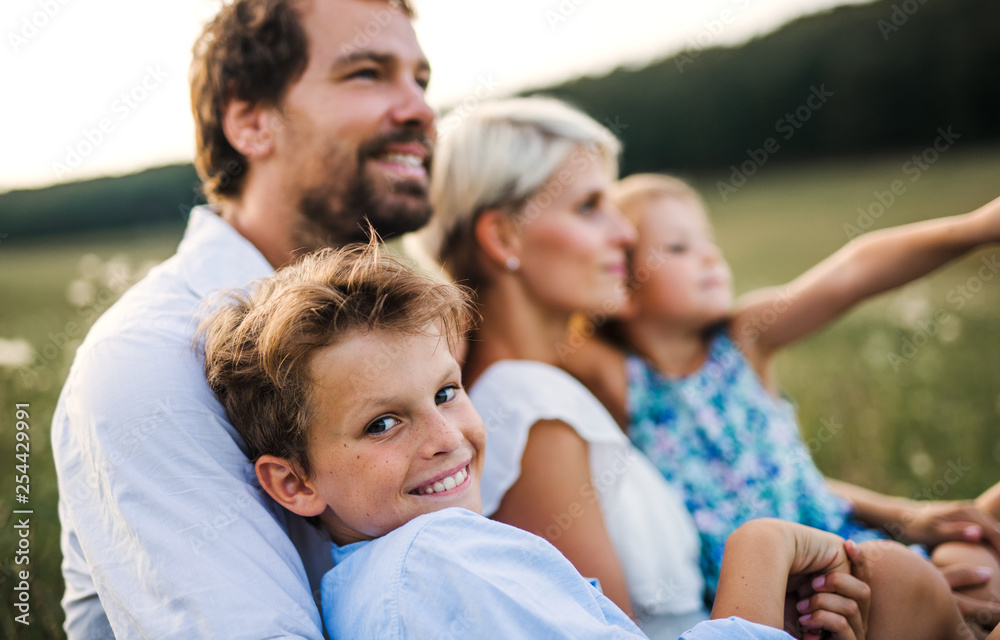 Young family with small children in summer nature at sunset. Young family with small children in summer nature at sunset.