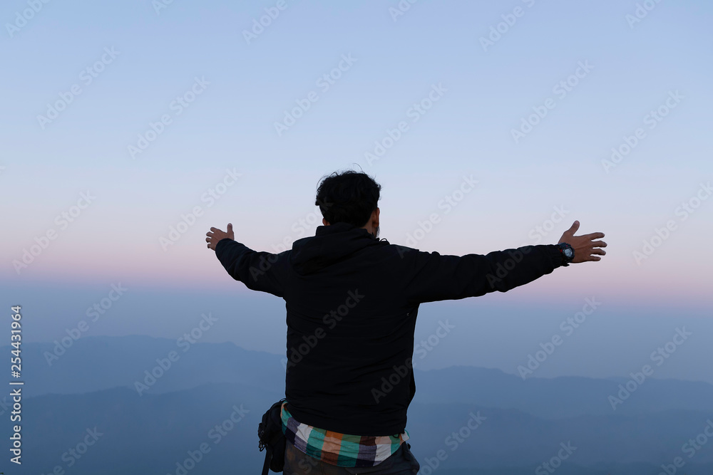 thankful man open arms to the sunrise stand top of mountain