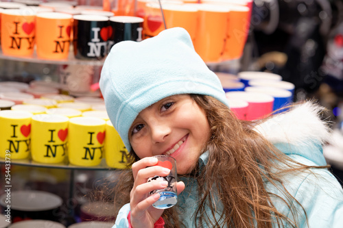 Photography Happy smiling young girl visiting New York City in winter wearing hat and touchi