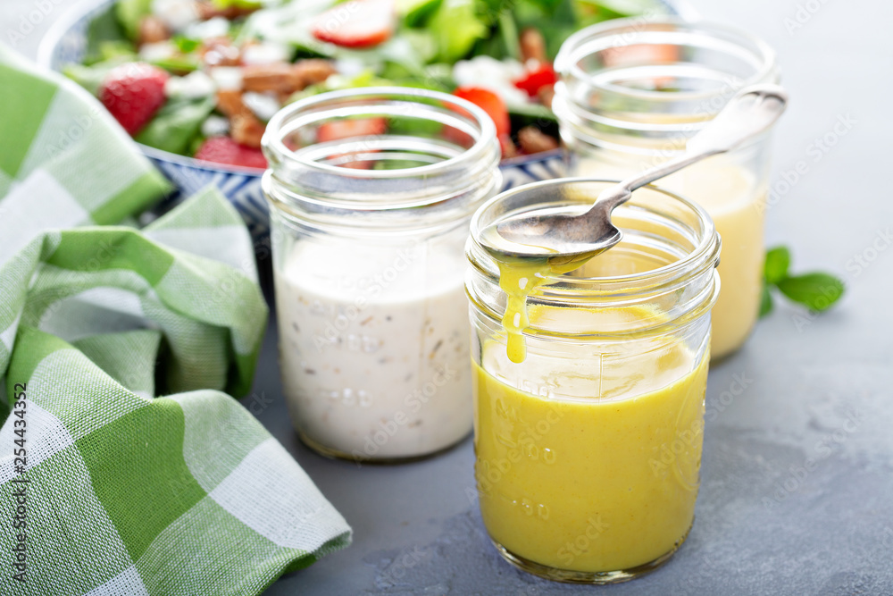 Φωτογραφία Variety of salad dressings in glass jars with ranch, italian and honey mustard