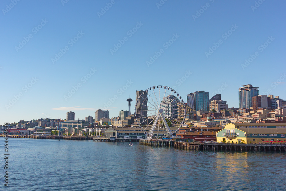 A view on Seattle city from the Puget Sound bay waters, USA. Cityscape on a sunny afternoon in summer.