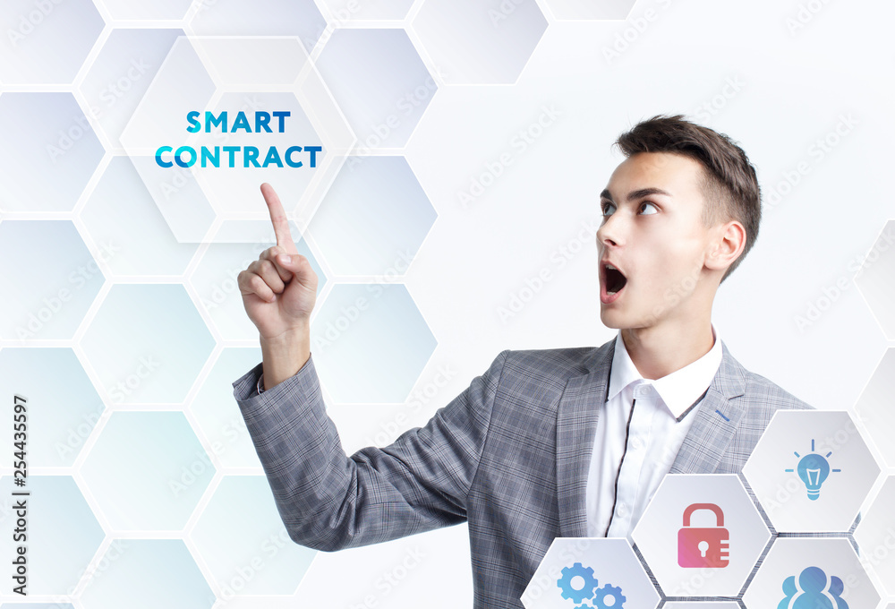 The concept of business, technology, the Internet and the network. A young entrepreneur working on a virtual screen of the future and sees the inscription: Smart contract The concept of business, technology, the Internet and the network. A young entrepreneur working on a virtual screen of the future and sees the inscription: Smart contract