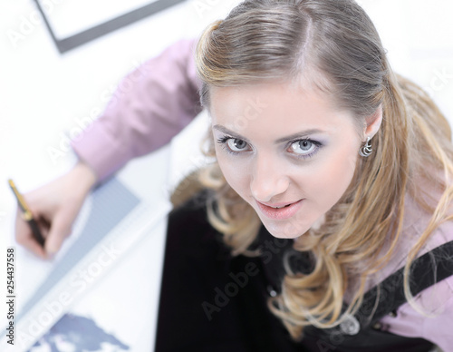 view from the top. young woman sitting at Desk