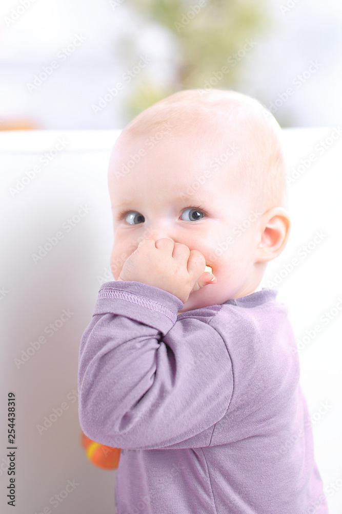 close up.cute baby eating a cookie while sitting on the couch close up.cute baby eating a cookie while sitting on the couch