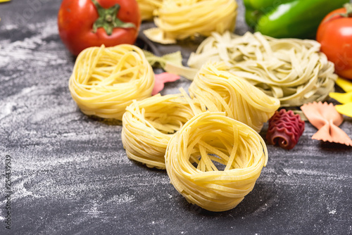 Raw Pasta Italian Traditional Food Tagliatelle and Farfalle Vertical Vegetables