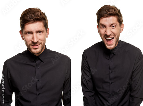 Handsome man in a black shirt makes faces, standing against a white background