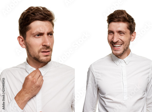 Handsome man in a white shirt makes faces, isolated on a white background photo