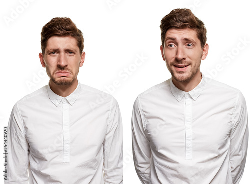 Handsome man in a white shirt makes faces, isolated on a white background