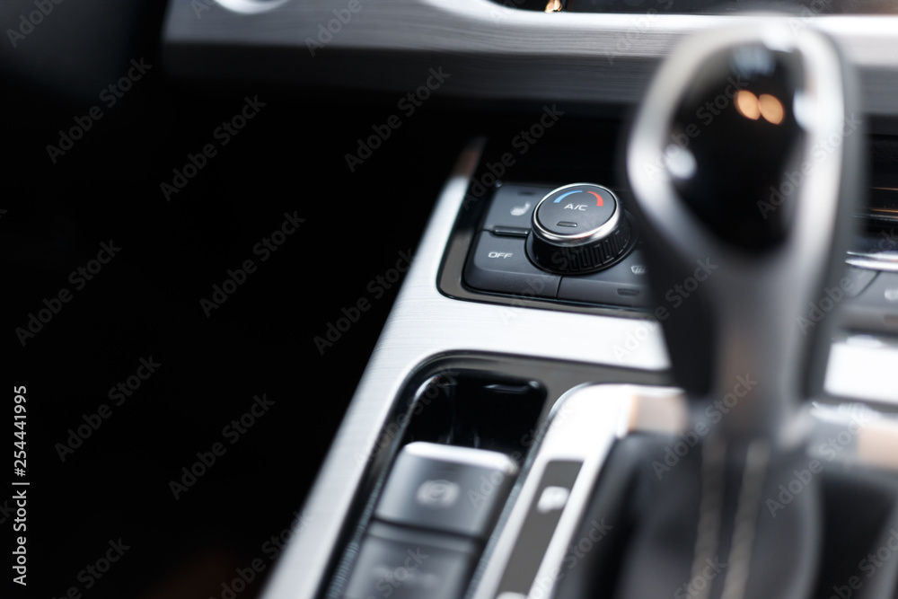 Air conditioning button inside a car. Climate control unit in the new car. Modern car interior details. Car detailing. Selective focus Air conditioning button inside a car. Climate control unit in the new car. Modern car interior details. Car detailing. Selective focus