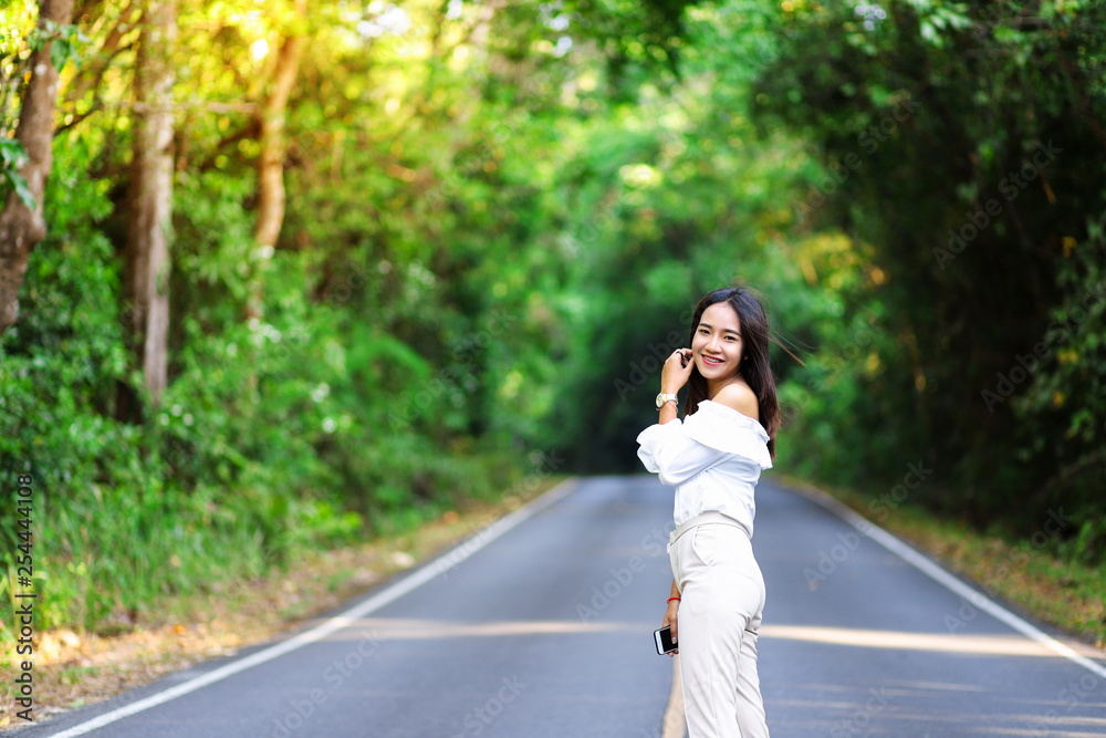 woman standing on the road in national park woman standing on the road in national park