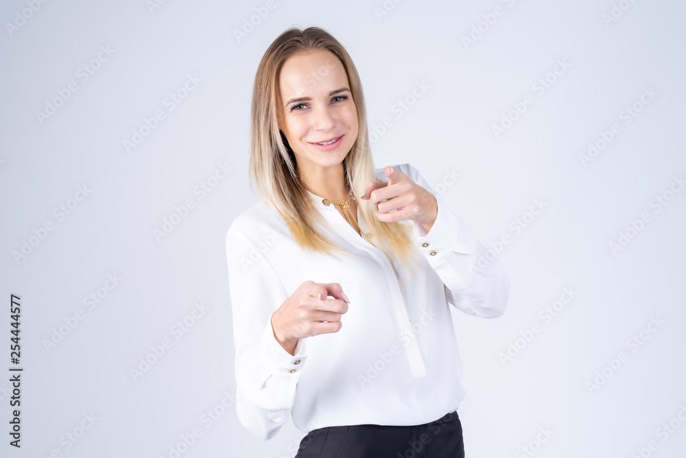 Beautiful girl is standing on a white background and shows on you Beautiful girl is standing on a white background and shows on you