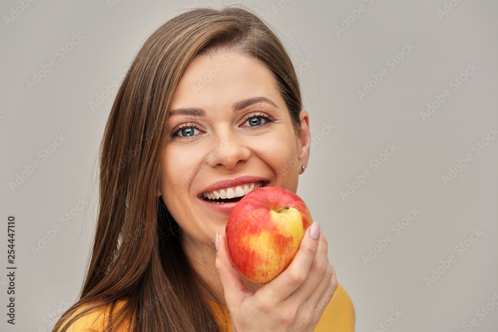 young woman with toothy smiling holding red apple. young woman with toothy smiling holding red apple.