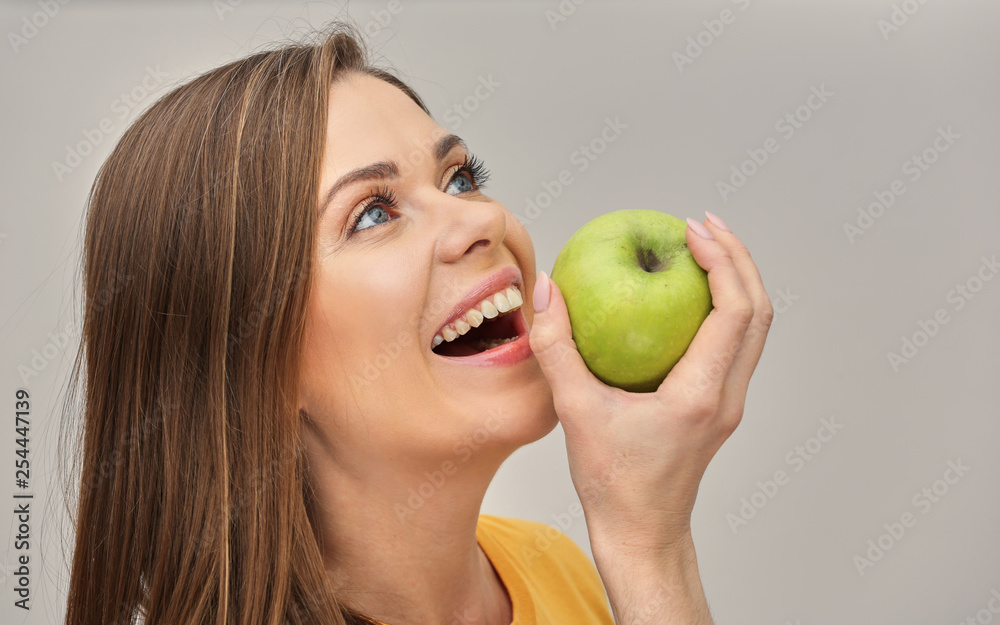 close up portrait of smiling woman with healthy teeth holding green apple. close up portrait of smiling woman with healthy teeth holding green apple.