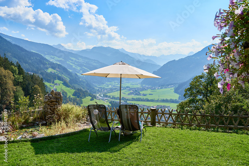 Lounge Chairs and Parasol with stunning view over Valley of Zillertal in Tirol in Austria photo