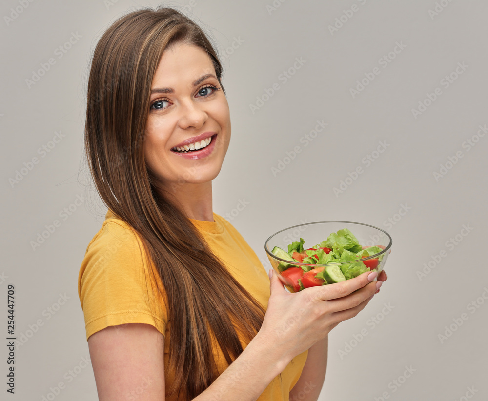 Smiling woman holding salad in glass bowl. Smiling woman holding salad in glass bowl.