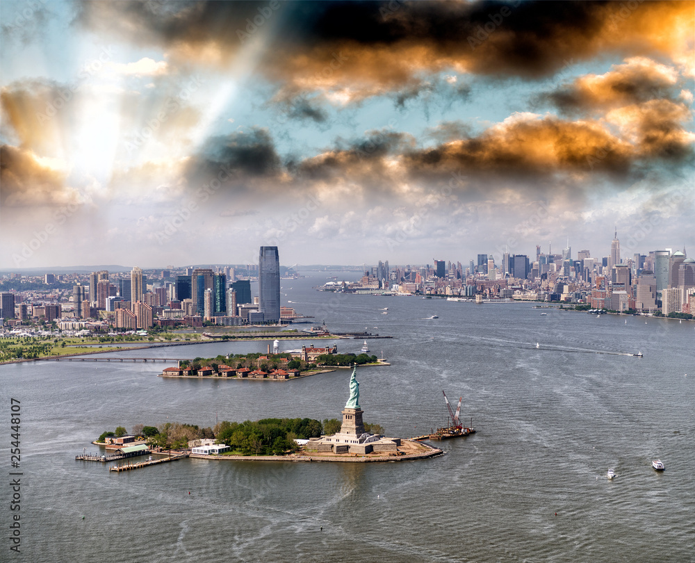 Helicopter view of Statue of Liberty with Lower Manhattan and Jersey City in the background, New York City