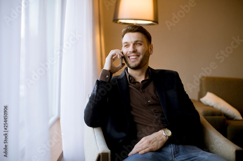 Young man using mobile phon...
