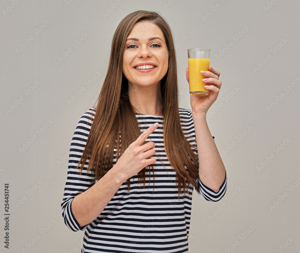 woman wearing striped shirt holding glass with orange juice and pointing finger. woman wearing striped shirt holding glass with orange juice and pointing finger.