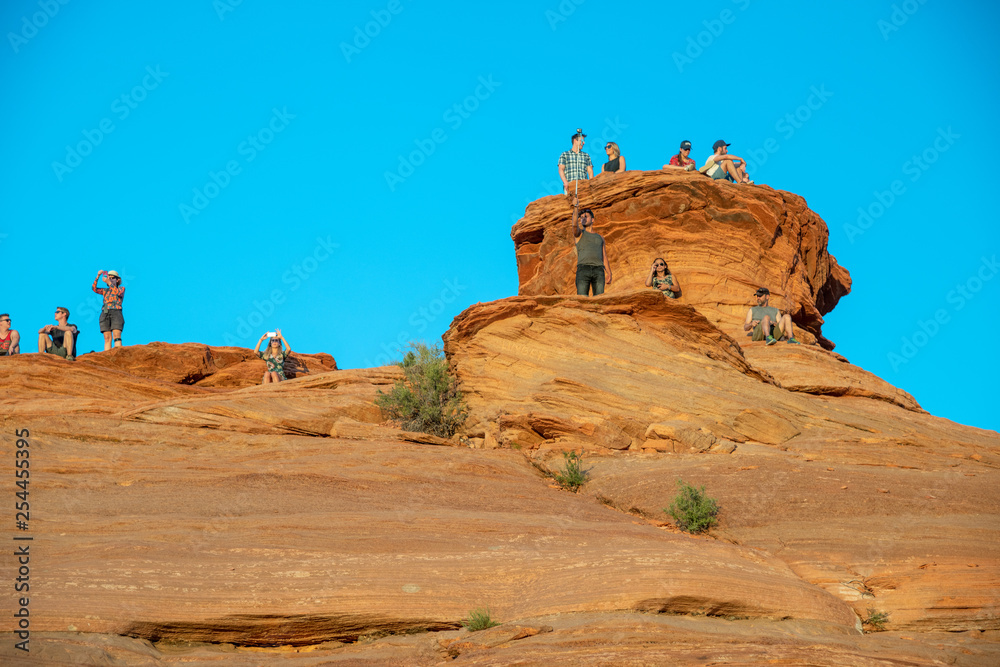 PAGE, AZ - JUNE 26, 2018: Tourists take pictures of Horseshoe Bend at sunset. This is a famous tourist attraction