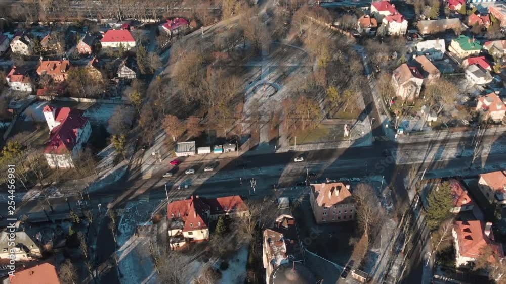 Aerial view of old houses and road with moving modern cars on a sunny day Aerial view of old houses and road with moving modern cars on a sunny day