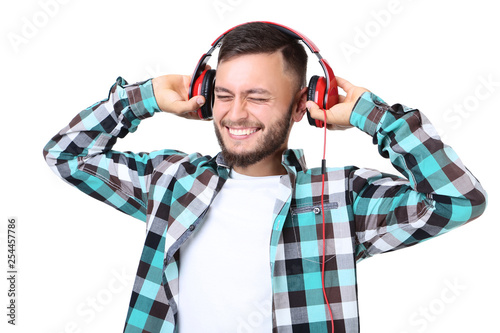 Young man with red headphones on white background