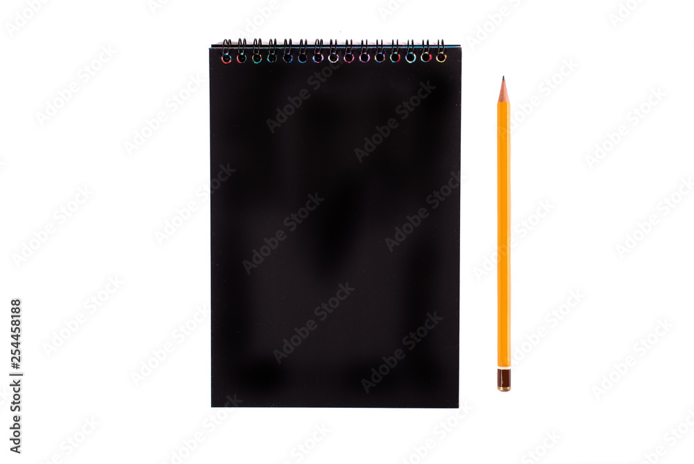Top view of closed black cover notebook with pencil on white desk background Top view of closed black cover notebook with pencil on white desk background