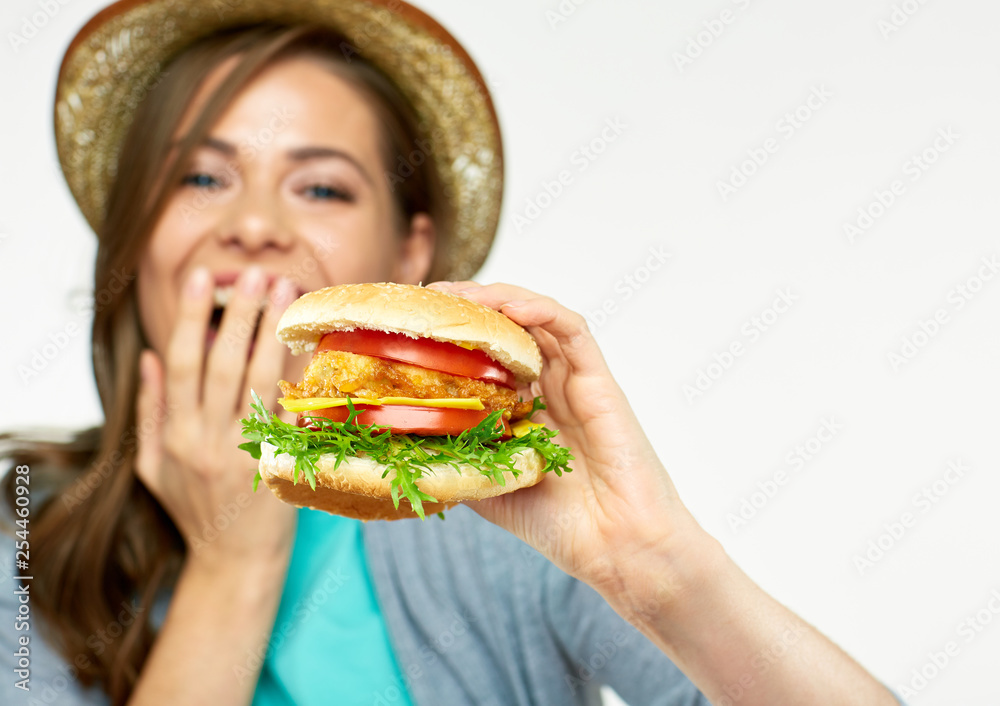 girl holding big burger in front of face.