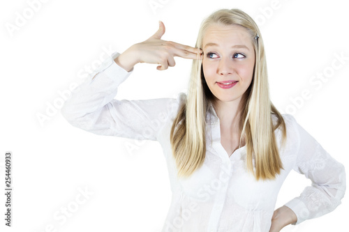Blonde, young woman pulling a gun gesture at her head.isolated on white, copy space