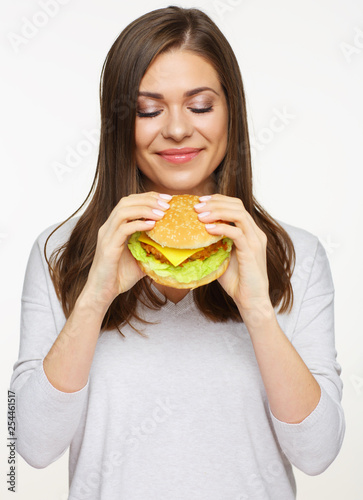 girl holding burger looking at him.