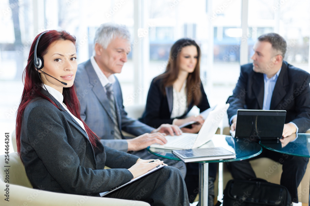 Business people in the office talking about business, using laptop