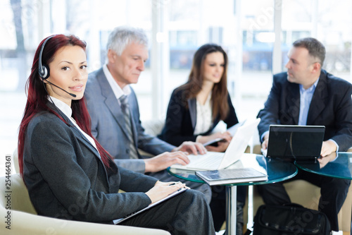 Business people in the office talking about business, using laptop