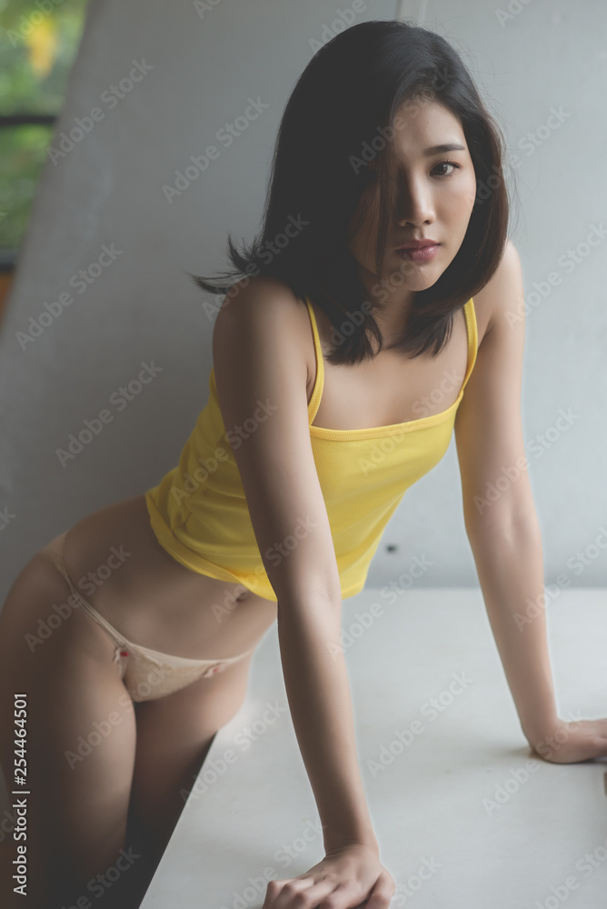 asian sexy woman shot hair in yellow lingerie Stock Photo | Adobe Stock
