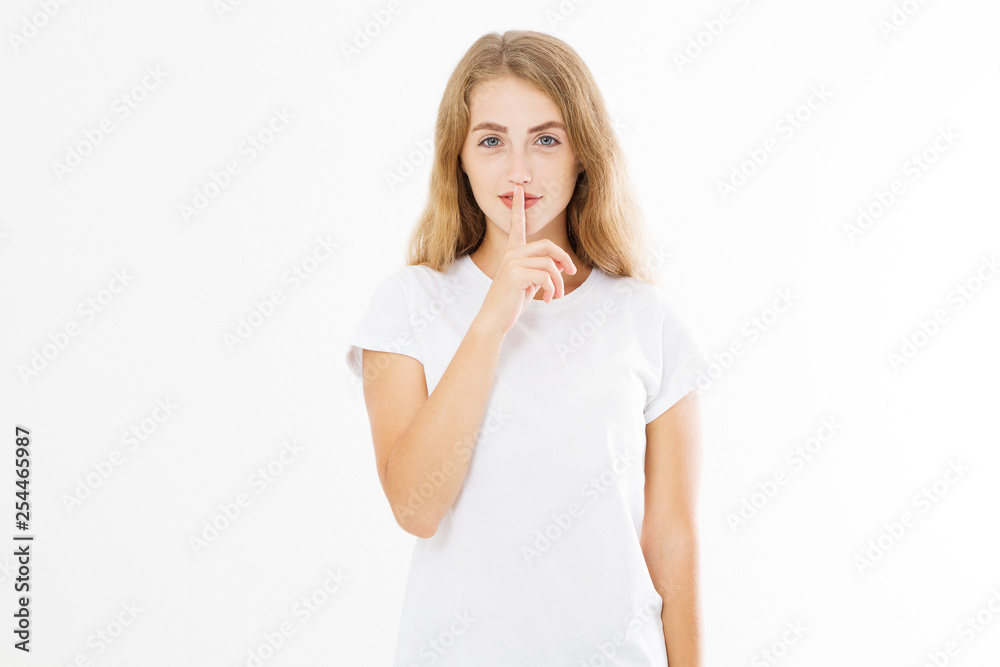Shhh sign. Young woman showing shh gesture to keep a silent. Girl in template white t shirt keep a secret. Quiet place and silence time. Copy space Shhh sign. Young woman showing shh gesture to keep a silent. Girl in template white t shirt keep a secret. Quiet place and silence time. Copy space